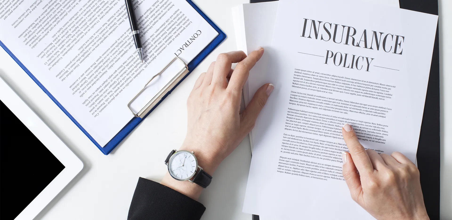 Someone reading a document titled 'Insurance Policy.'