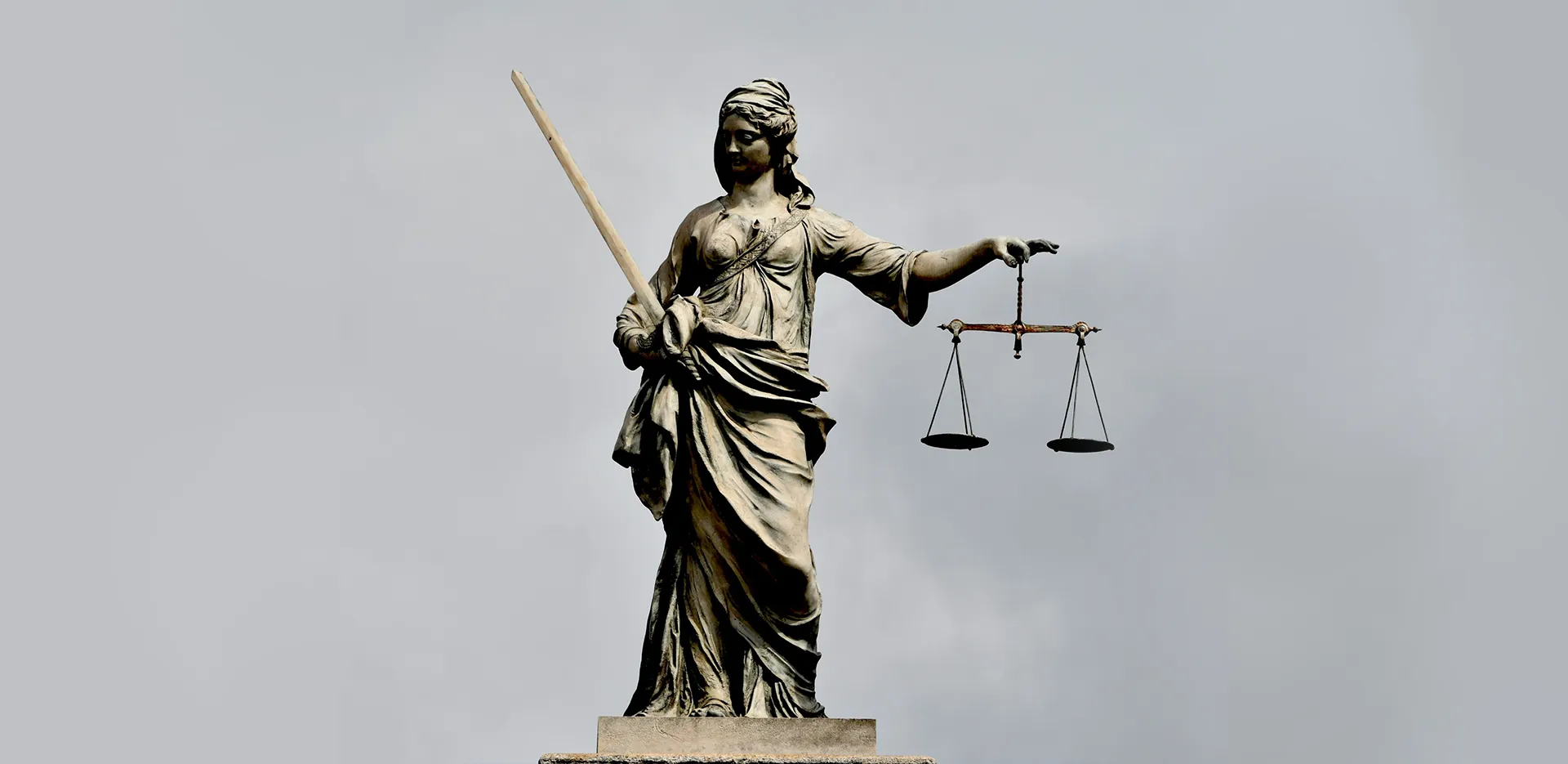 A statue of Justice, holding a blade in one hand and scales in the other.
