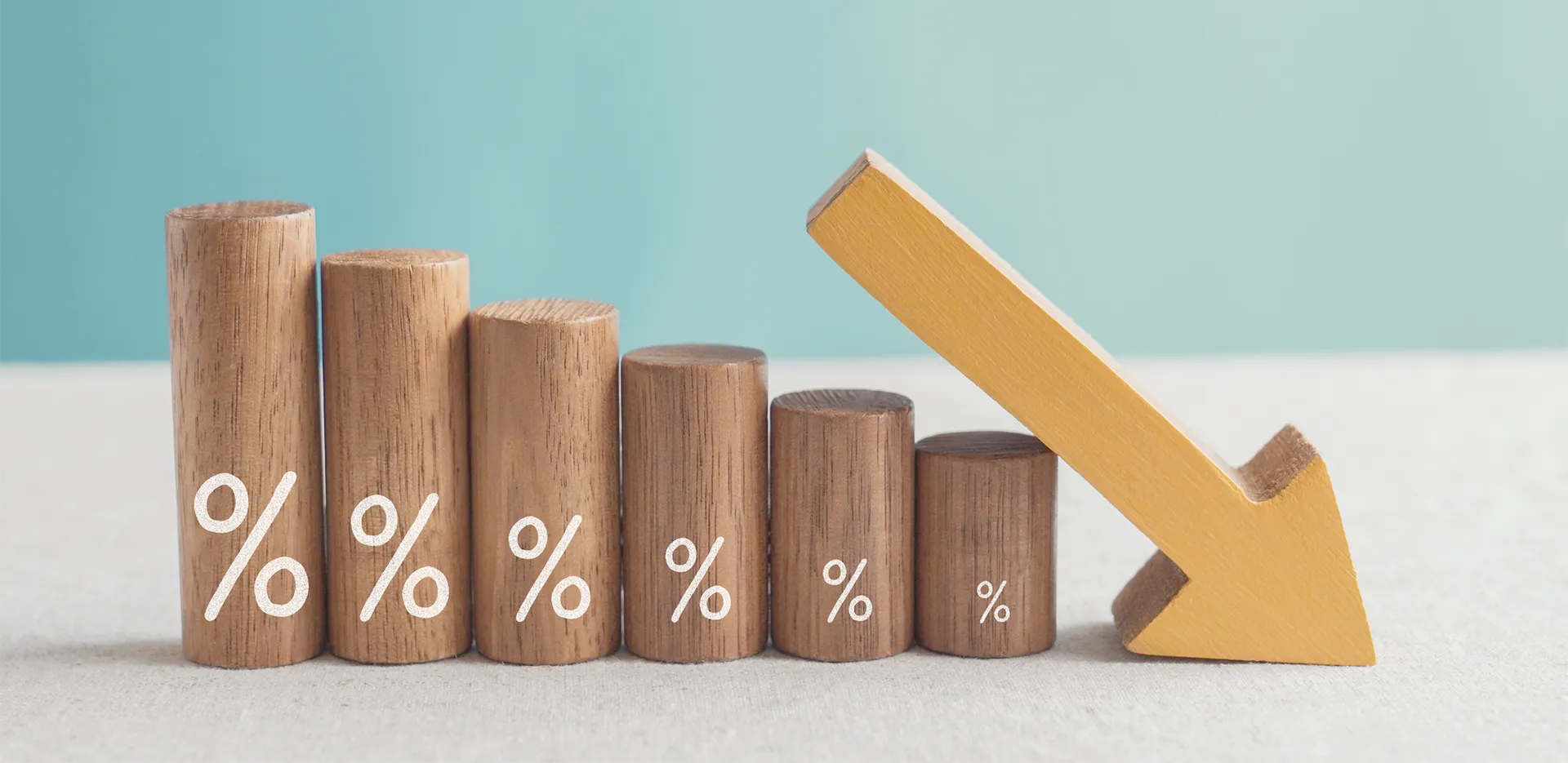Wooden blocks stacked to mimic a bar graph with an arrow pointing down.