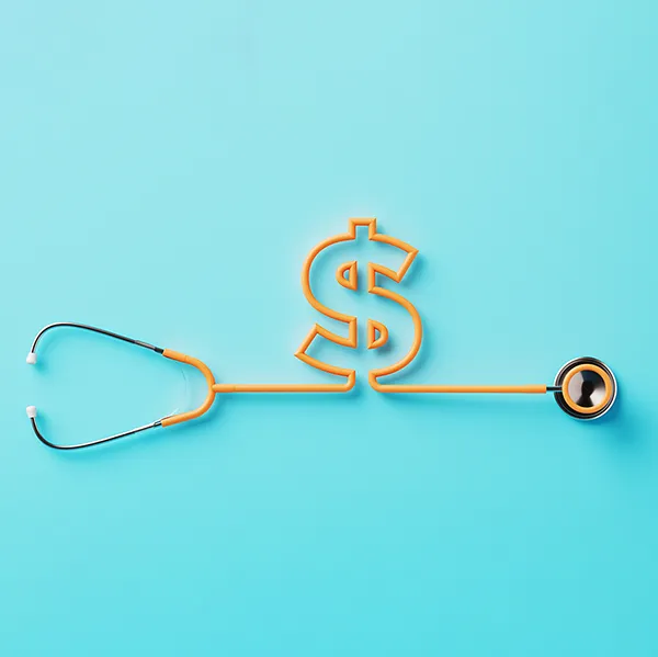 A yellow stethoscope in the shape of a dollar sign against a blue background.