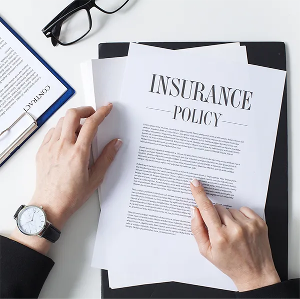 Someone reading a document titled 'Insurance Policy.'