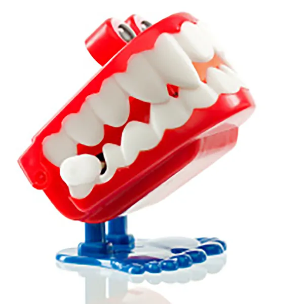 Two pairs of plastic toy teeth with feet.