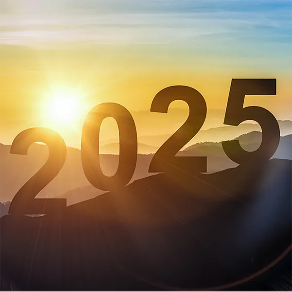 The numbers '2025' on top of a mountain in the sunset.