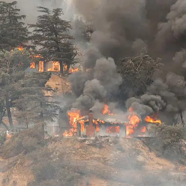 A home burning in a wildfire.
