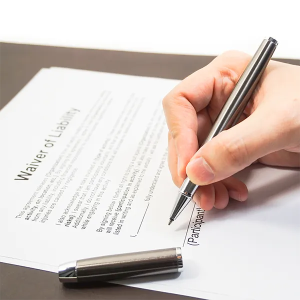 Someone signing a waiver of liability.