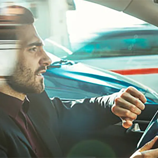 A person speeding while checking their watch.