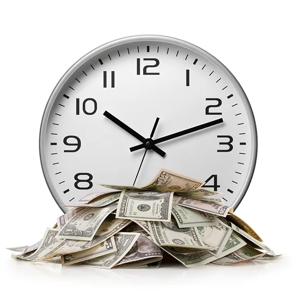 A pile money in front of a clock.