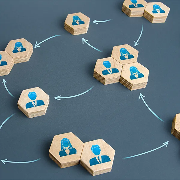 Hexagonal wood pieces with illustrations of office workers on them