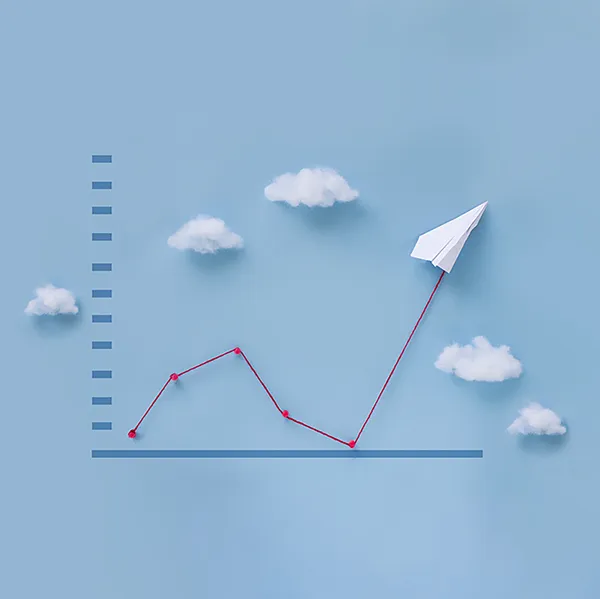 A line graph with a paper plane and cotton ball clouds. The line is red yarn.
