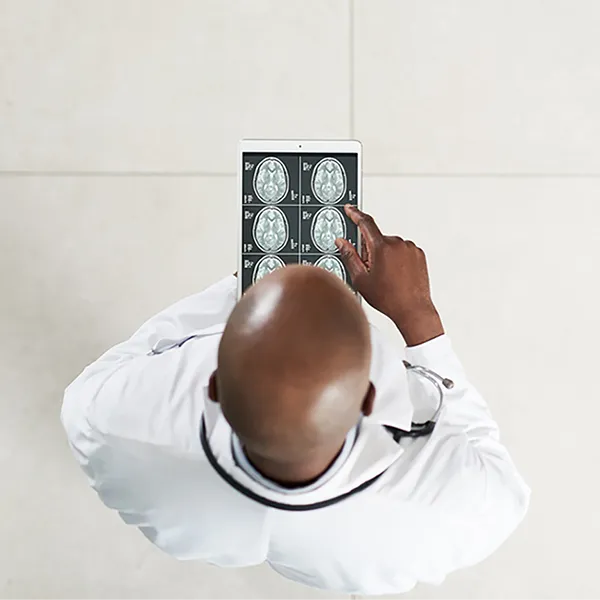 A doctor looking at scans of a patient's brain.