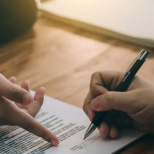 Two professionals reviewing insurance paperwork.