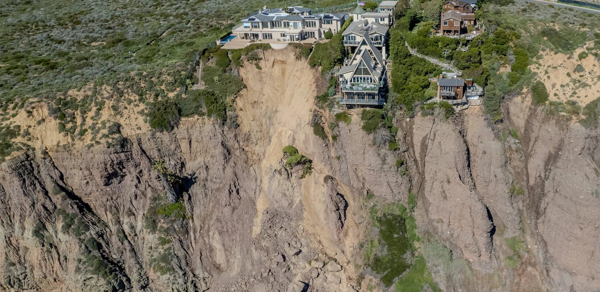 A large home on the edge of a cliff that looks unstable.
