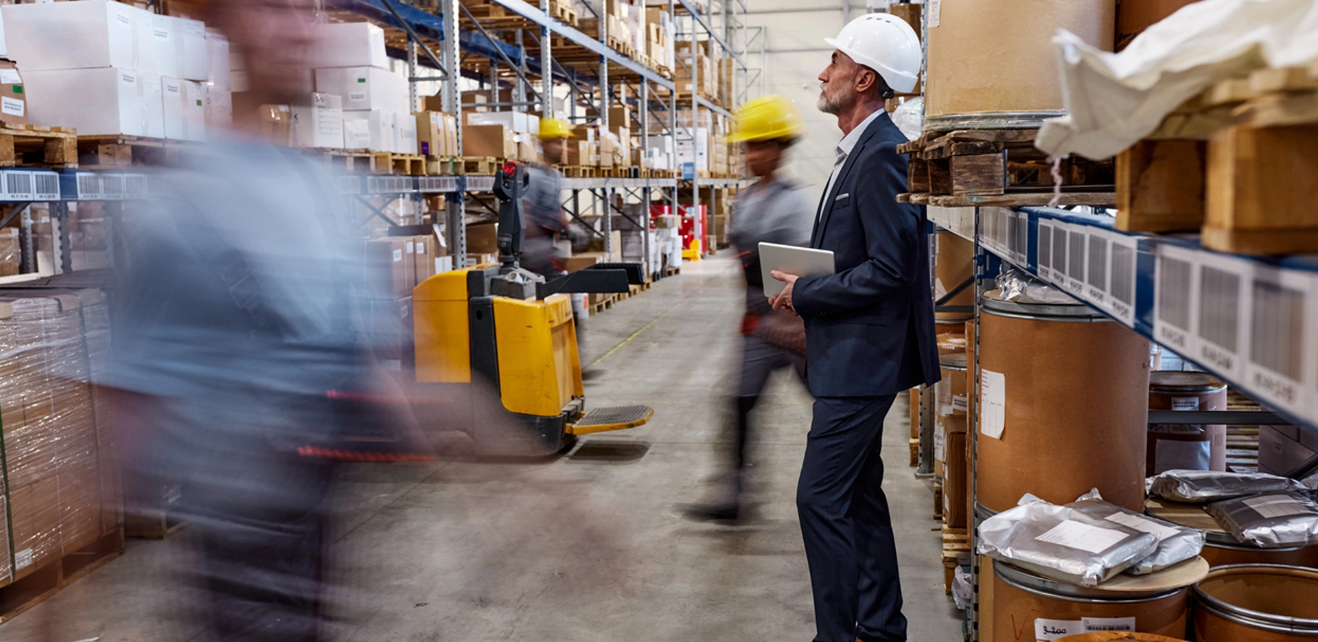 manager standing and observing workers